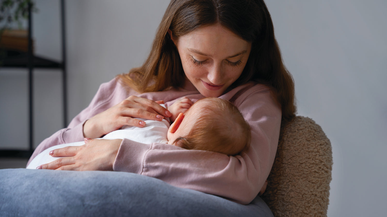 Close-up of a mother gently feeding her newborn baby, symbolizing maternal care and health.